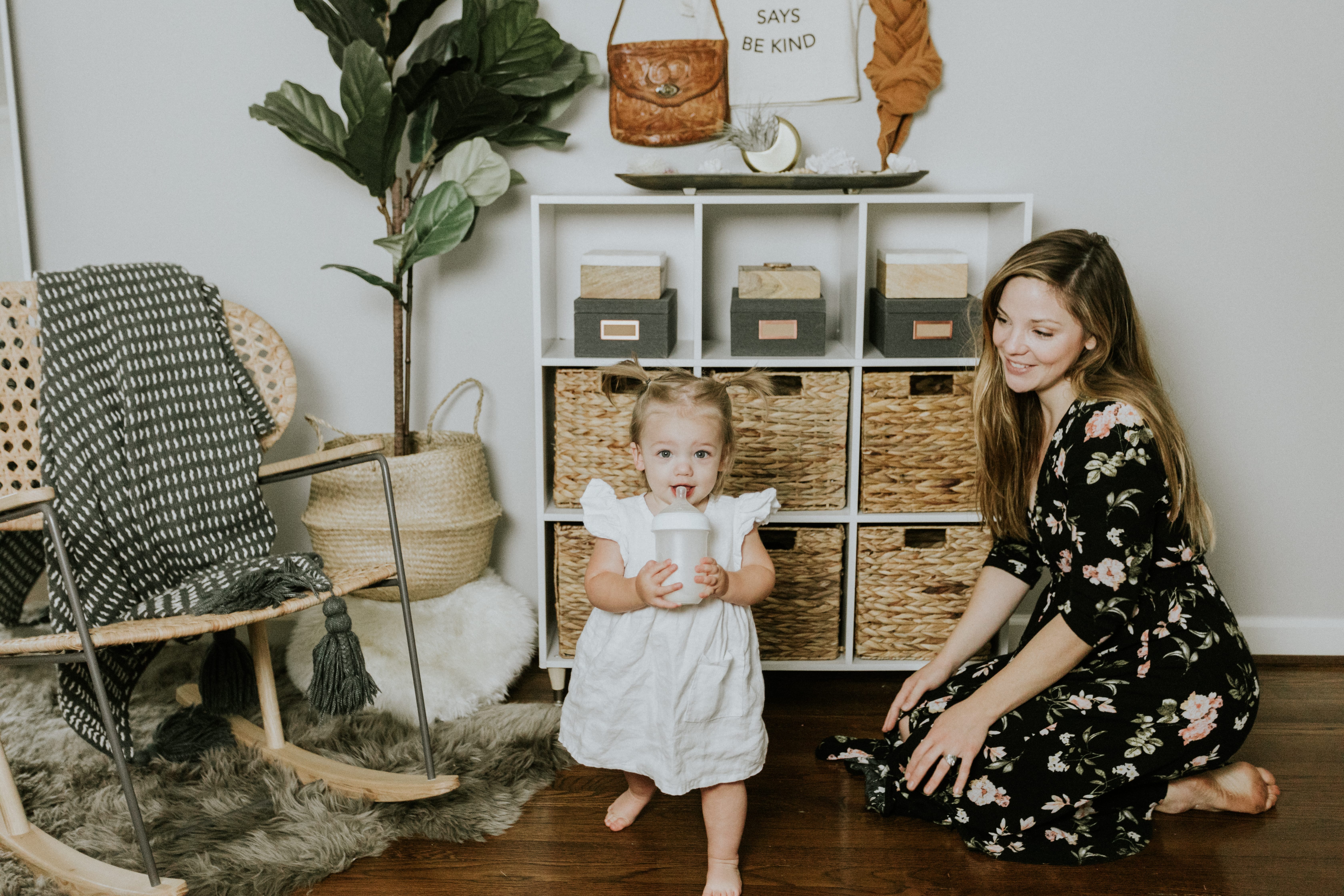 Modern nursery decor with basket shelves and a beautiful hanging rack to display our favorite things